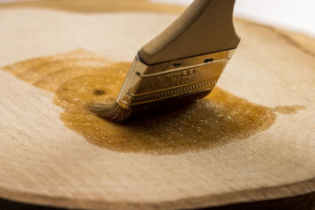 Pentacryl being brushed onto wood